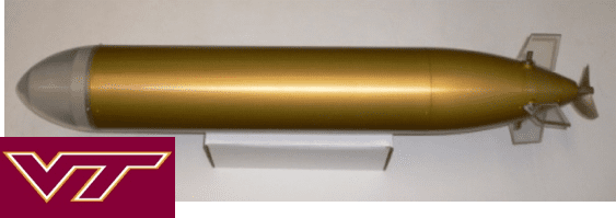 A gold colored metal pipe sitting next to a wall.